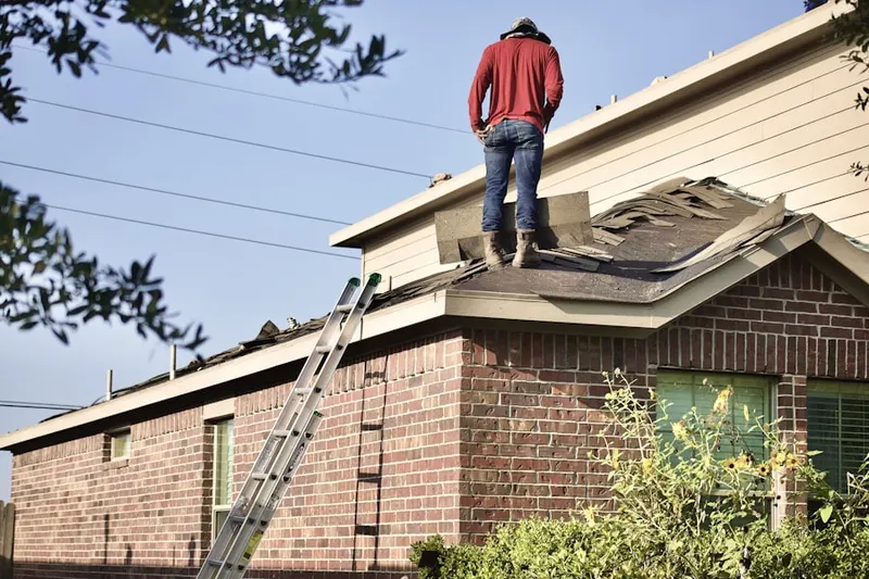 Professional roofer working on a residential roof in Swedetown